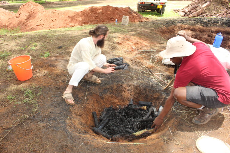 CarbonConnect co-founder Nando Knodel and OFA biochar consultant,Tafadzwa Nyamande demonstrate how to produce biochar using a cone-shaped pit at CIMMYT-Zimbabwe premises .